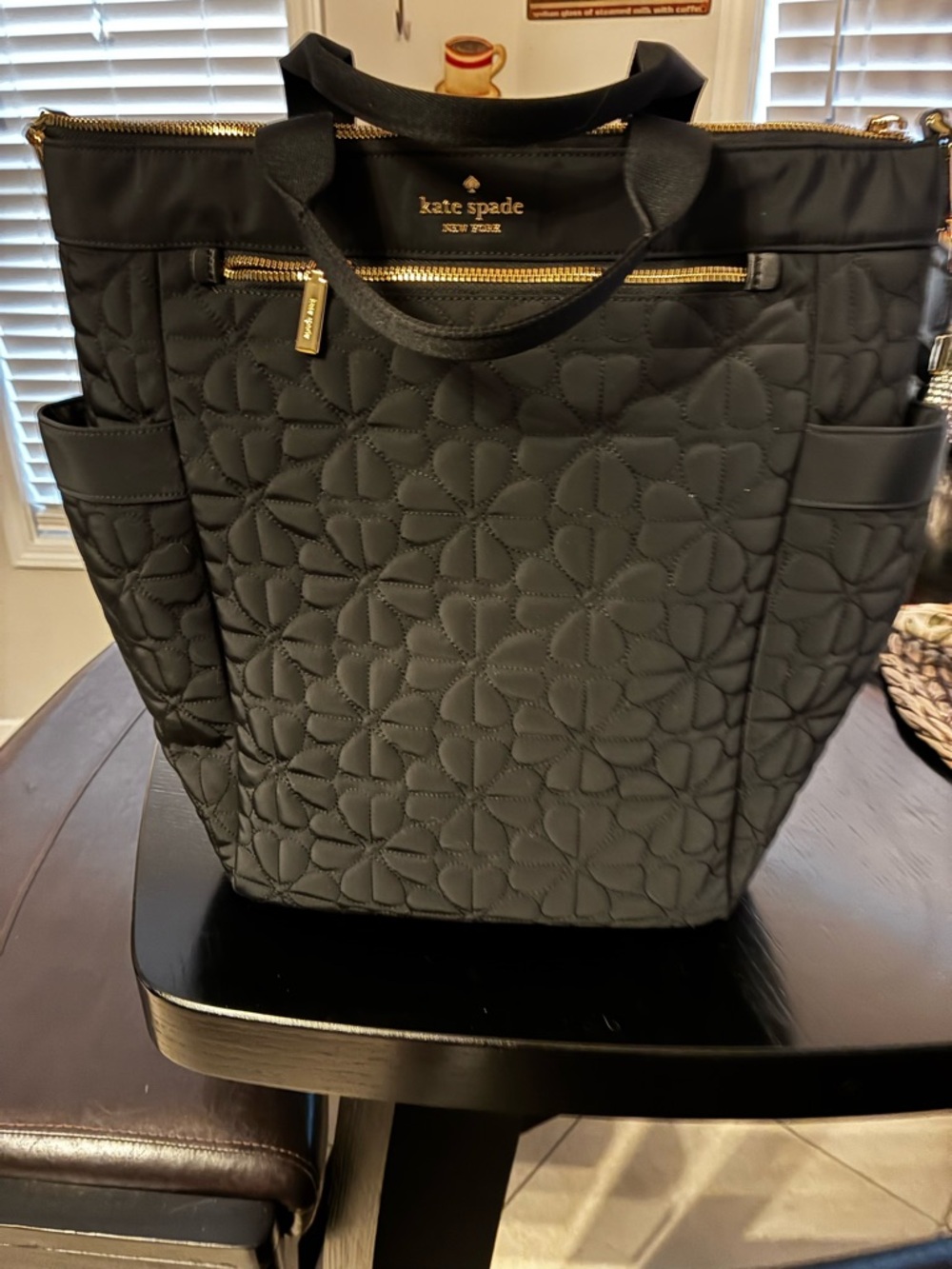 kate spade black quilted floral-stitched tote with gold hardware and extra strap